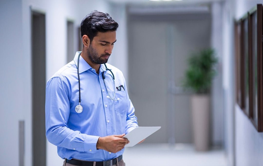 A doctor looking at his ipad 