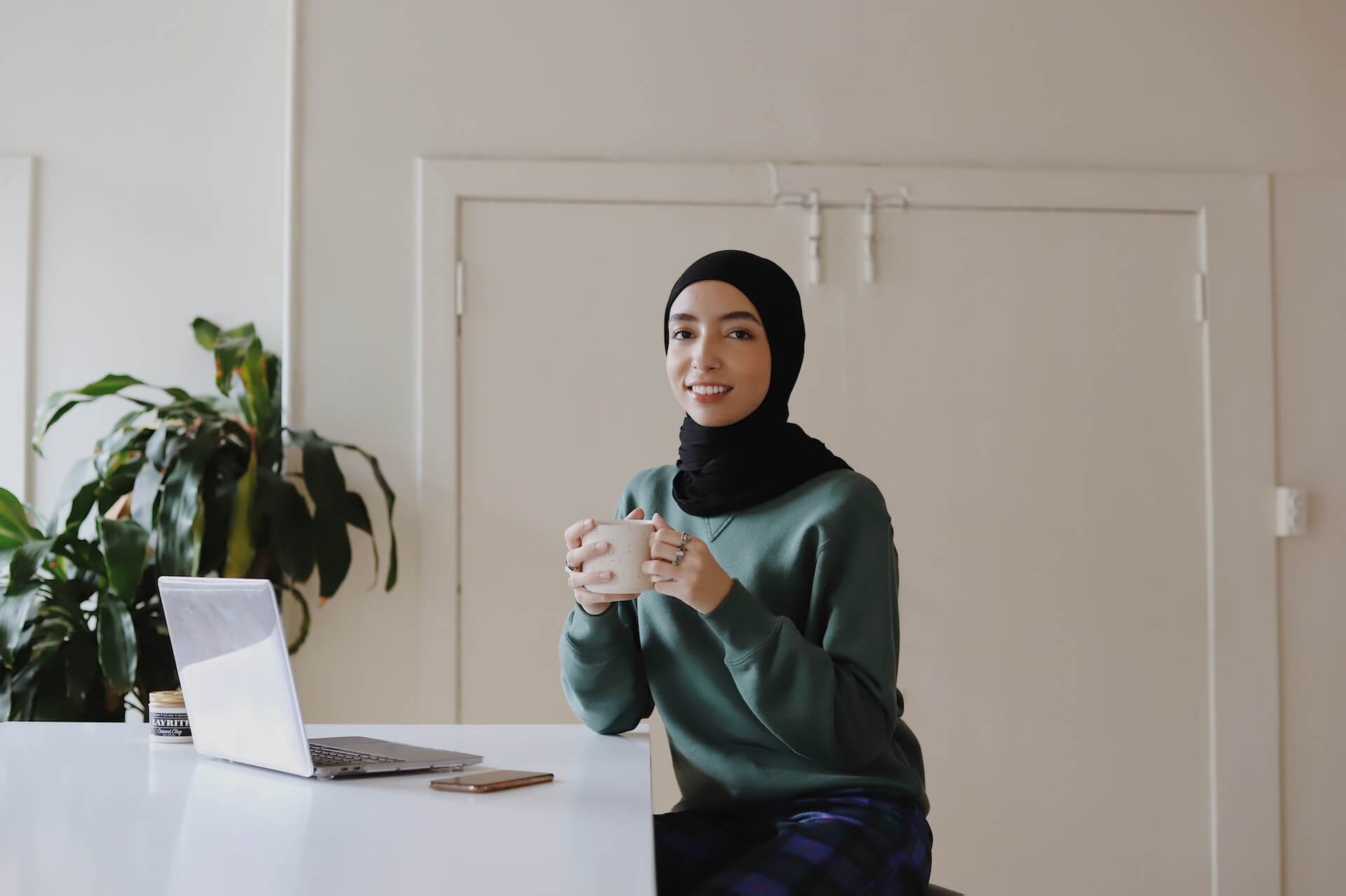 Person at their desk with a drink